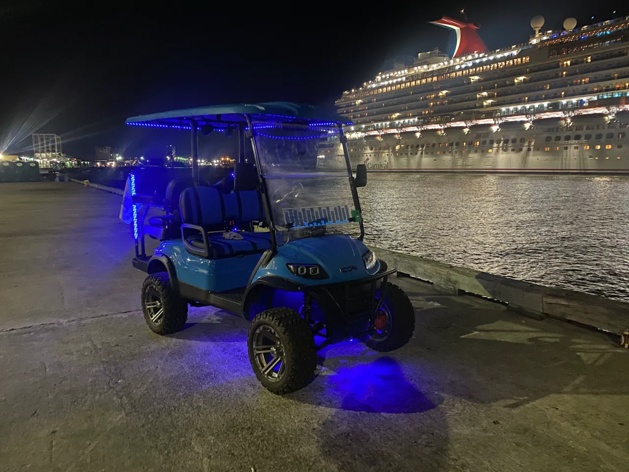 Blue golf cart photographed by Coconut Carts in Galveston at night