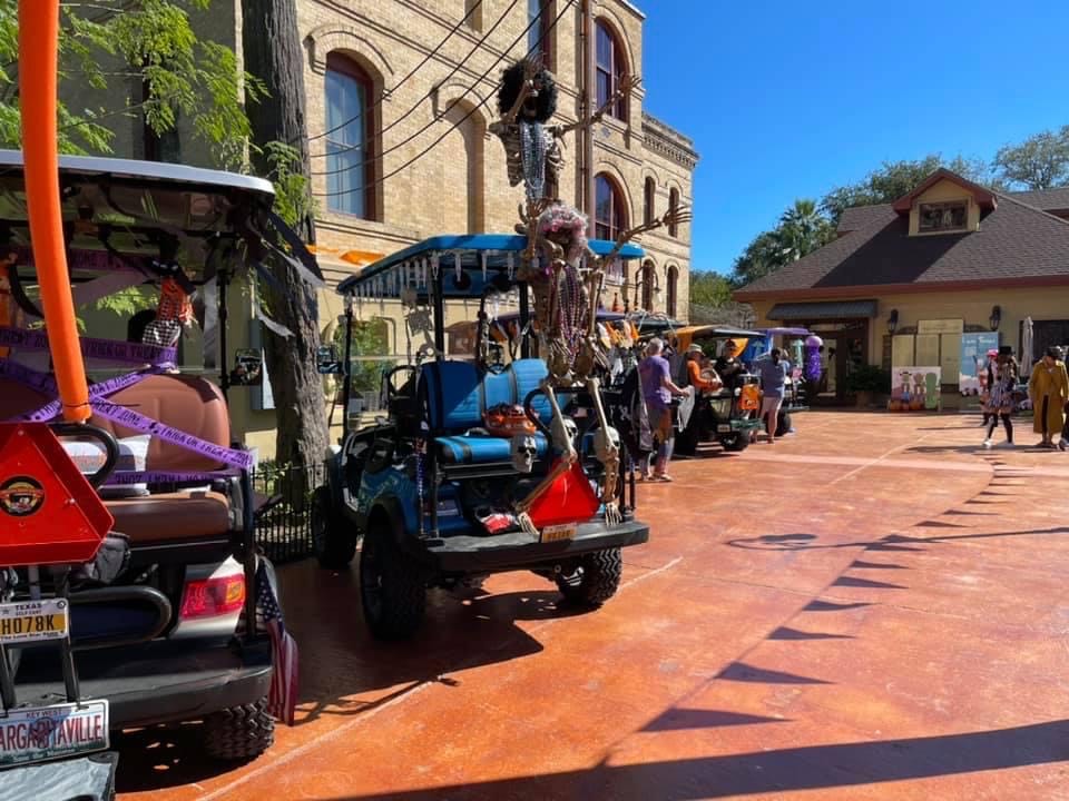 Decorated golf carts and neighbors at a local event